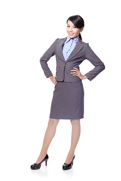 Happy businesswoman holding briefcase and putting her hand on hip on white background