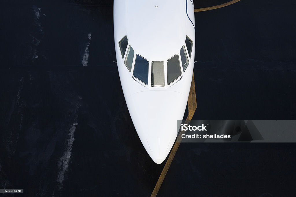 Business Jet pilot cabin windows, shot from above "Photo of a Business Jet at the airport, front part shot from above" Corporate Jet Stock Photo