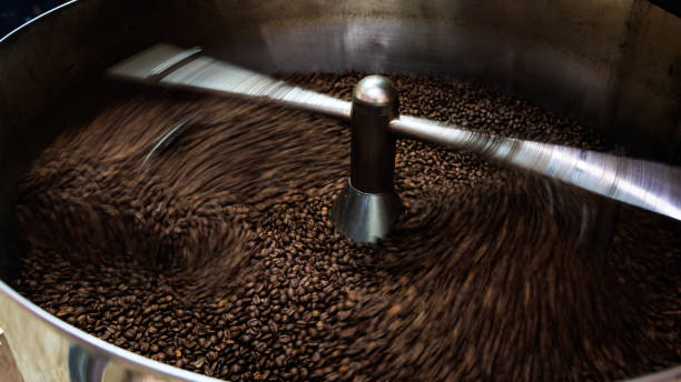 istock coffee beans and roasted spinning cover professional machine, close up to soft focus, take low speed photo to need movement and coffee beans detail concept, 1785378108