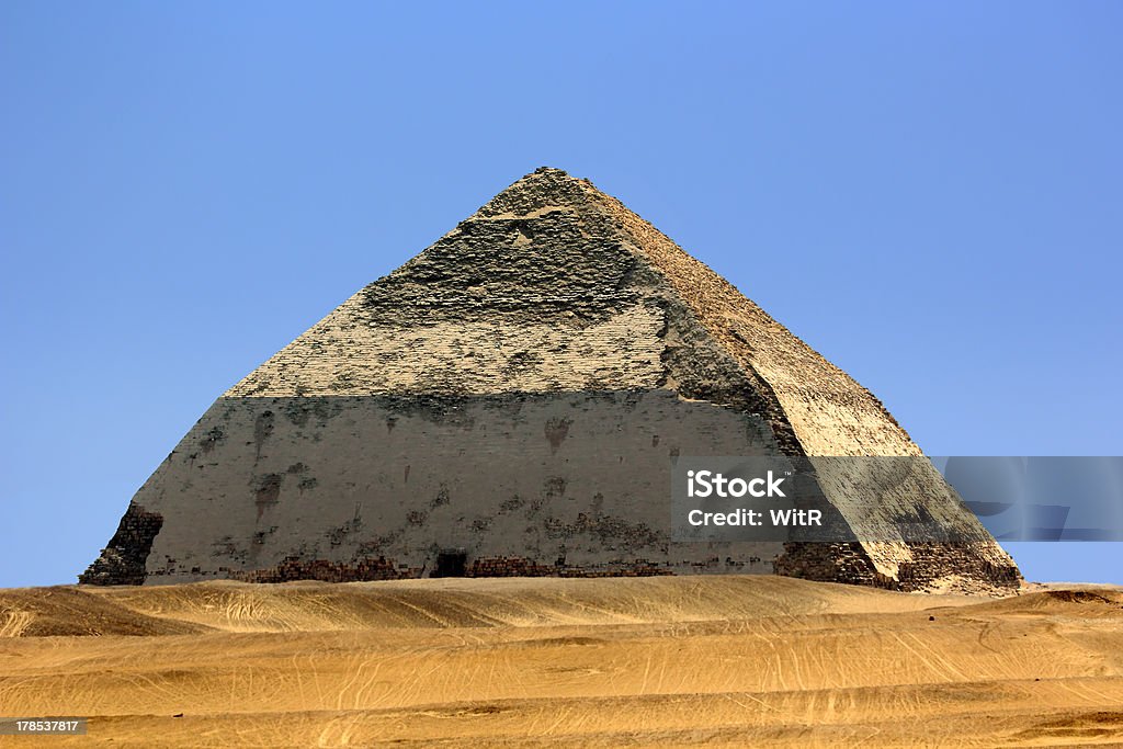 Bent Pyramid "Egypt. Dahshur (or Dashur). The Bent Pyramid (also knew as False, or Rhomboidal Pyramid because of it changed angle slope) of Pharaoh Sneferu with well preserved original limestone casing. The Pyramid Fields from Giza to Dahshur is on UNESCO World Heritage List since 1979" Bent Pyramid Of Snefru Stock Photo