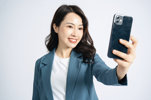 Image of young Asian business woman on background