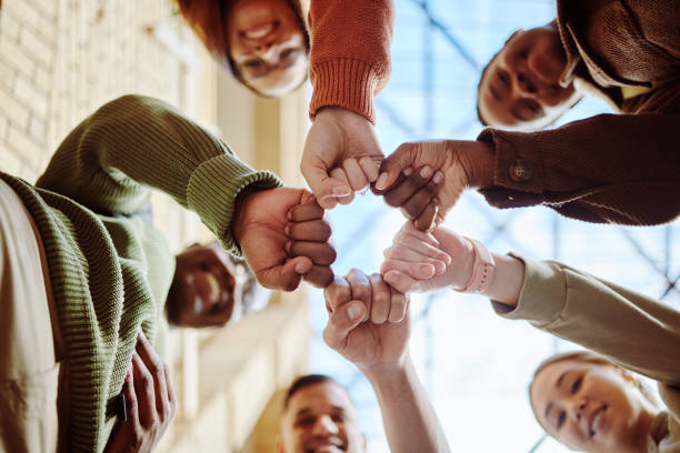 istock Below, students and fist hands in group for support, motivation or education in sunshine at college. Diversity, fist bump and community with teamwork, studying or scholarship at university for future 1785379763