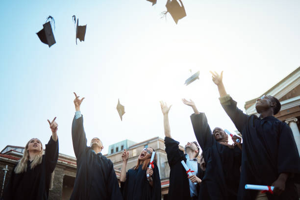 istock Diversity, graduation hat or students with celebration, university or happiness outdoor. Young people, men or women with degree completion, education or knowledge for success, graduate or achievement 1785380365
