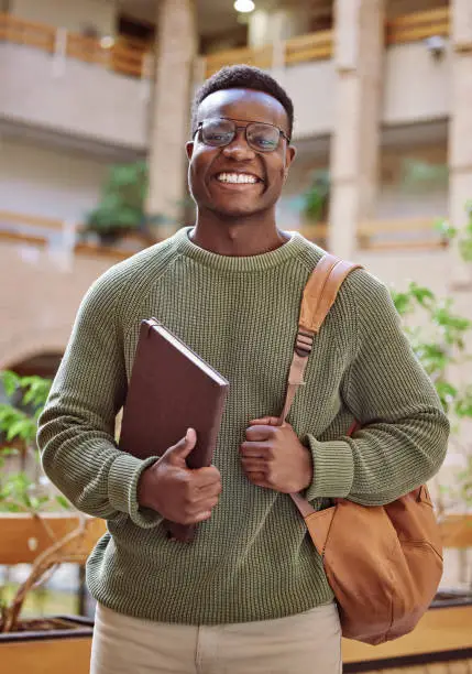 Photo of Campus, student and portrait of black man at college building, academy and school for education in Atlanta. Happy university student studying with motivation for knowledge, learning or future success