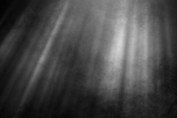 istock White and gray smoke against black background with light beams 1785389484