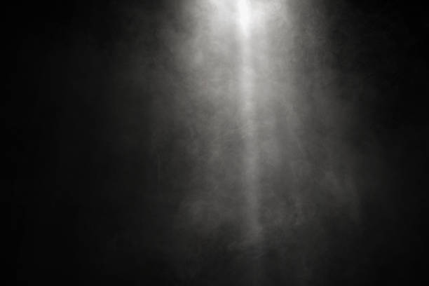 istock White and gray smoke against black background with light beams 1785389725