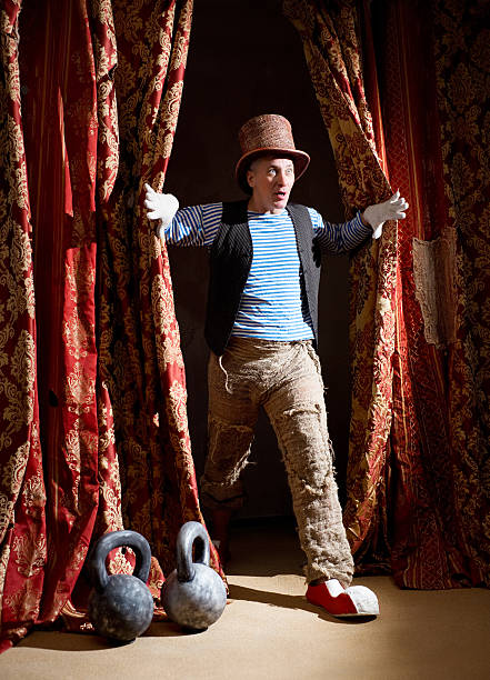 istock Clown coming out from behind the curtain with surprised face 178538997