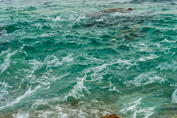 istock closeup emerald sea waves nar the coast, beautiful natural background 1785399420