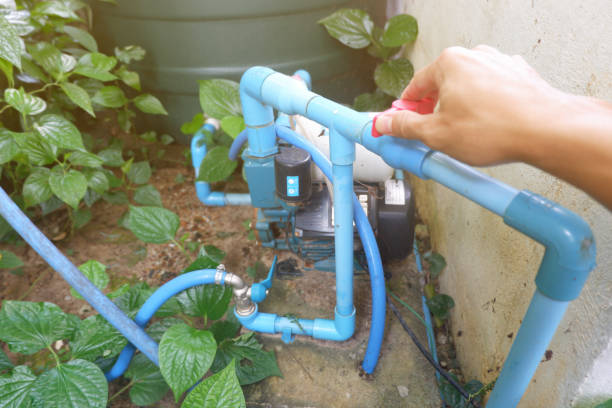 istock Man's hands turning the water valve on the water pump motor. 1785408822