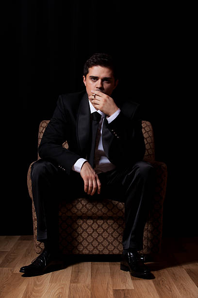 istock Man with cigarette sitting in vintage armchair 178541658