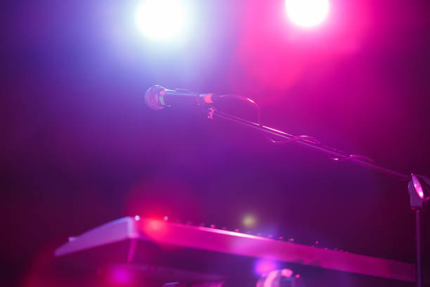 istock Microphone on stand on concert stage. Spotlight for a musician 1785423782