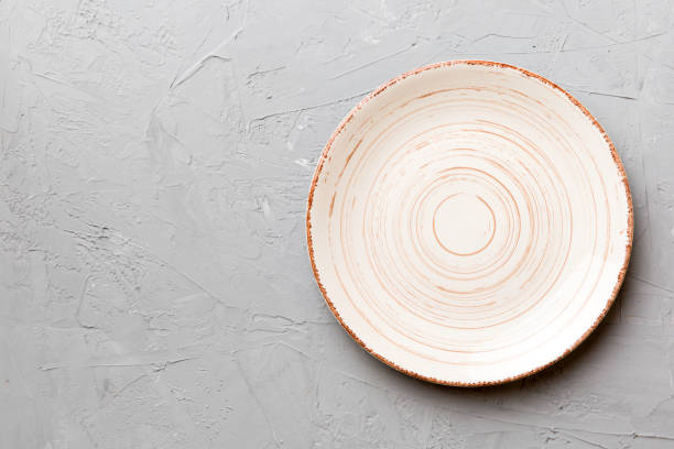 istock Top view of empty colorful plate on cement background. Empty space for your design 1785429961