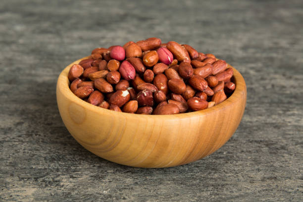 istock Fresh healthy peanuts in bowl on colored table background. Top view Healthy eating bertholletia concept. Super foods 1785430547