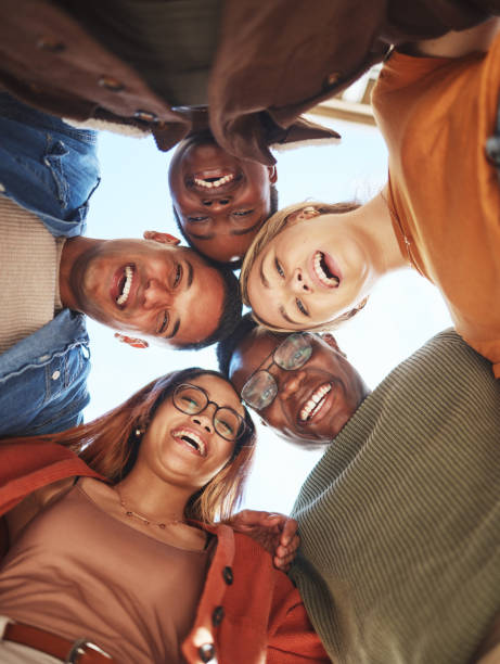 istock Group huddle, portrait smile and hug below for community, teamwork or trust together in the outdoors. Happy people smiling in diversity for solidarity or unity for team support or friendship 1785432293