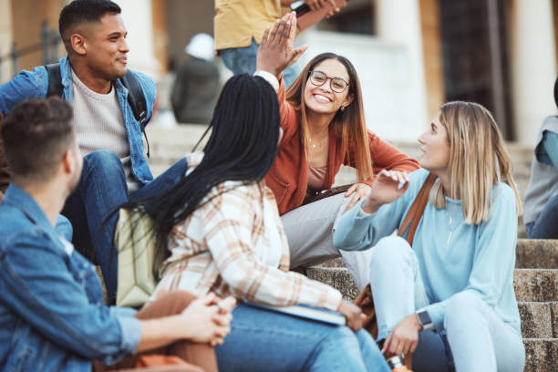 istock Talking, students or high five on university stairs, college campus bleachers or school steps for education diversity success. Smile, happy friends or partnership gesture in learning goals or target 1785432297
