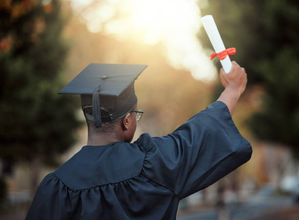 istock University graduation, certificate and back view of black man with motivation for learning goals, achievement or future. Male graduate student, diploma and celebration of success in college education 1785432822