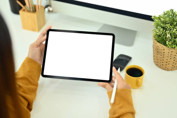 istock Above view of creative woman holding stylus pen and using digital tablet at office desk 1785437112