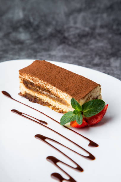 istock side view of chocolate sponge cake with strawberries and mint on a white plate 1785444283