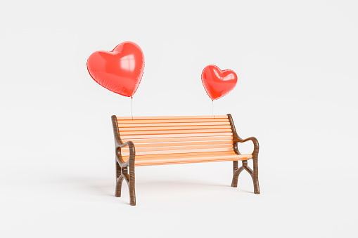 Red heart balloons tied to a wooden bench on a white background, symbolizing romance and love. 3d Rendering