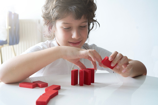 Cute Little Boy Playing with wooden block