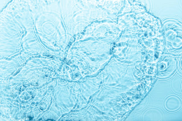 istock Defocus blurred blue color water ripple surface clear calm texture background with splashing bubbles water drop. Abstract and nature concept. Shiny water wave sunlight reflection shining copy space. 1785451519