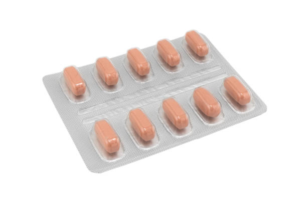 istock Macro shot pile of tablets pill in silver blister packaging isolated on white background. Aluminium foil blister pack. Pharmacy products. Medicine pills and drugs close up. Pills background 1785455346