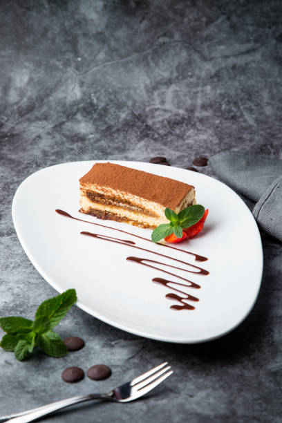 istock side view of chocolate sponge cake with strawberries and mint on a white plate 1785460571