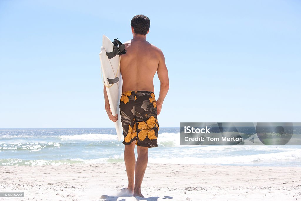 Homme jogging sur la plage avec planche de surf - Photo de 35-39 ans libre de droits