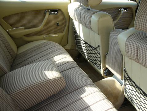 Rear beige checkered seats and doors of retro car