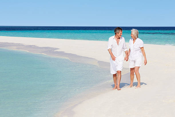 istock Senior romantic couple walking on sunny tropical beach 178546899
