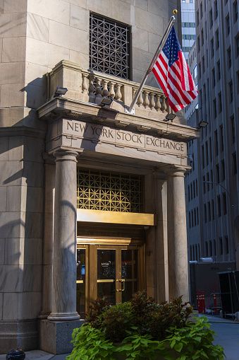 New York, NY, United States - July 24, 2023: Sunlight falling on the side entrance of the New York Stock Exchange, NYSE, in the financial district in Manhattan