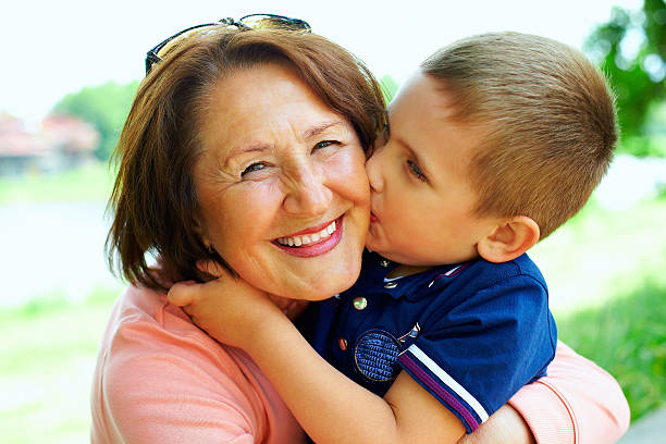 happy grandma with grandson embracing outdoor happy grandma with grandson embracing outdoor grandson photos stock pictures, royalty-free photos & images