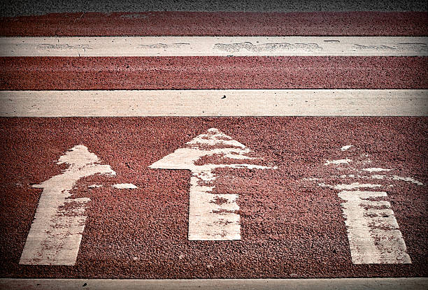 istock Pedestrian crossing with three arrows and lines on asphalt 178548428