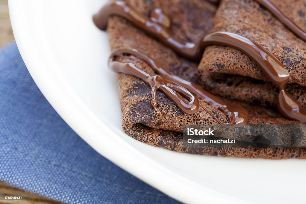 Chocolate pancakes Chocolate pancakes on white plate Baked Stock Photo