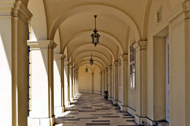 istock baroque style arched yellow stucco colonnade with columns and black wrought iron suspended exterior lanterns 1785485882