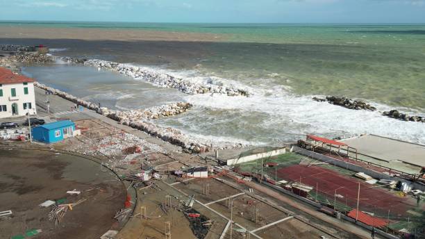 storm in marina di pisa, tuscany. fury of the waves on the coast, aerial view on a sunny morning - marina di pisa imagens e fotografias de stock