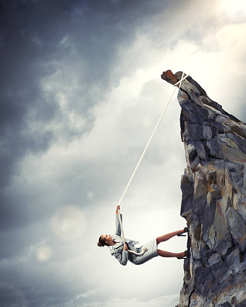 istock businesswoman climbing mountain 178549439