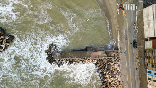 storm in marina di pisa, tuscany. fury of the waves on the coast, aerial view on a sunny morning - marina di pisa imagens e fotografias de stock