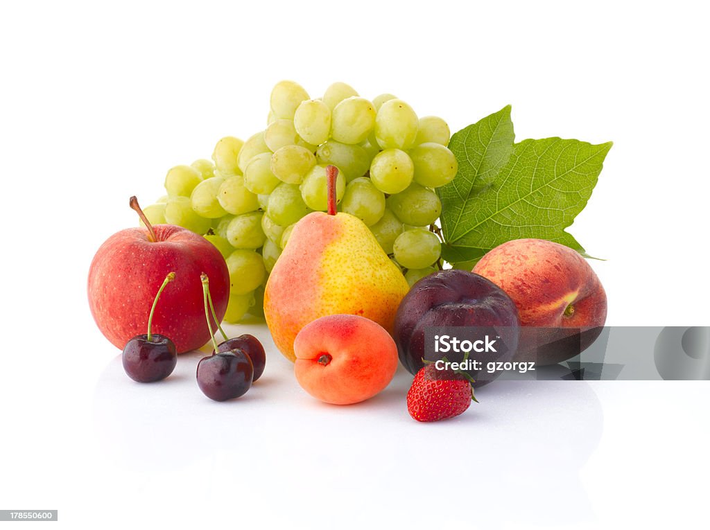Various fruits isolated on the white background Various, assorted fruits (grape, apple, pear, cherry, apricot, plum, peach,  strawberries) with leaf, isolated on the white background with soft shadow Fruit Stock Photo