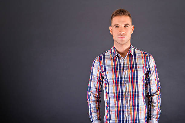 istock Man overdark background in squared shirt 178550703