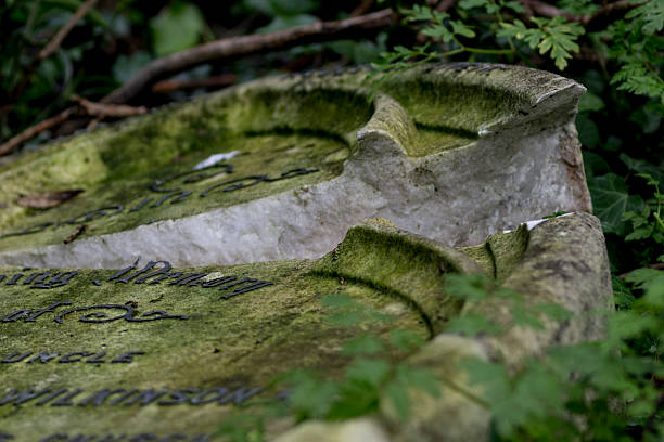 Broken Headstone in a dilapidated Graveyard stock photo