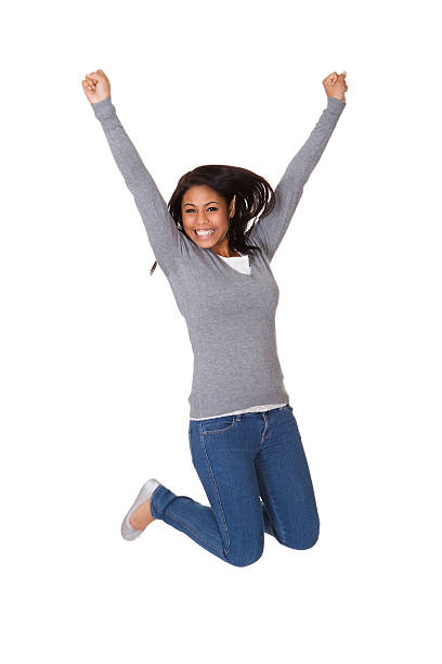 портрет восторге молодая женщина прыгать - women fist beautiful excitement стоковые фото и изображения