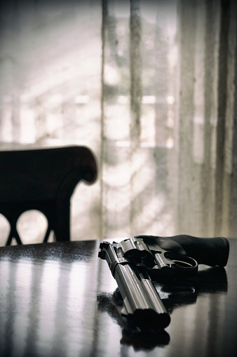 357 magnum revolver on a wooden desk. Toned Image.