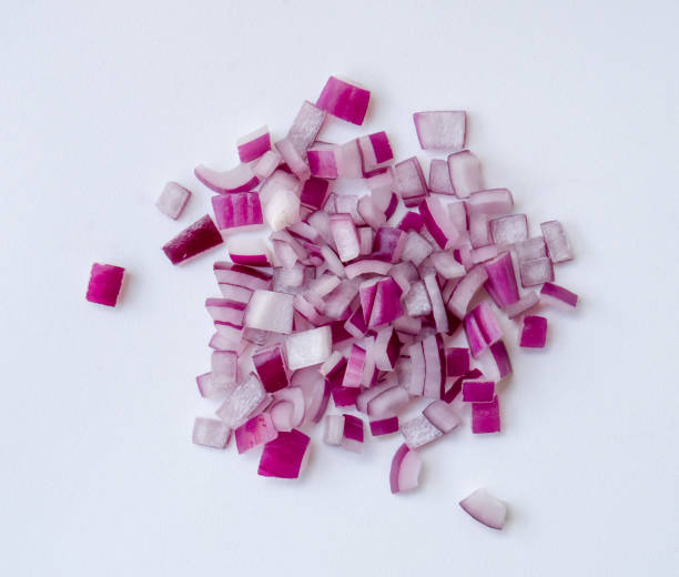 istock Red or purple onion chopped into small pieces in stack or pile isolated on white background. Red onions cuts 1785517440