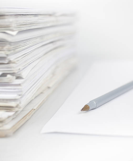istock Stack of papers next to a sheet with a pen on top of it 178551756