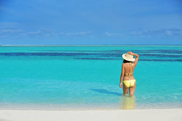 istock pretty woman resting on tropical  beach 178551971