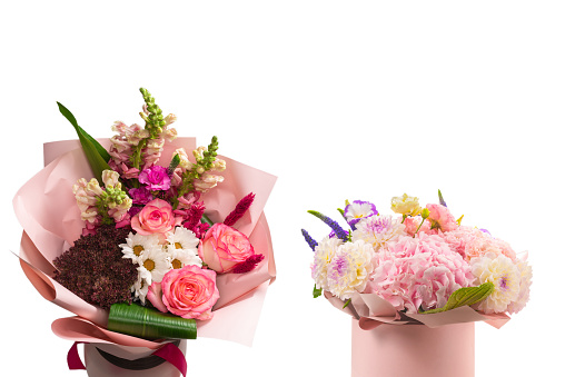 A shot directly above a bouquet of flowers on a table with gift bags.