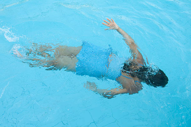 istock girl is swimming under water in waterpool 178552842