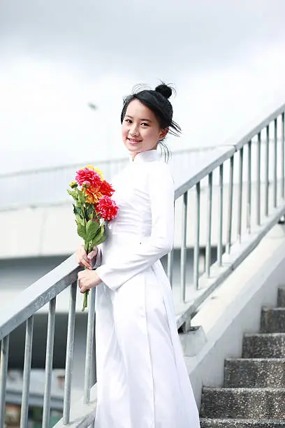 Vietnamese high school girl in white traditional dress aodai