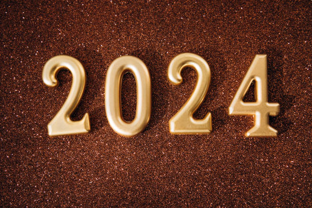 istock Background for greetings with empty space. Happy new year card. Golden figures 2024 on a brown shining sparkling background 1785529833